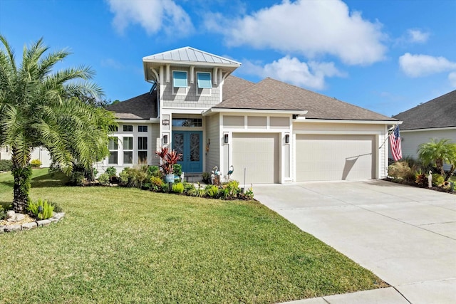 view of front facade with a garage and a front lawn