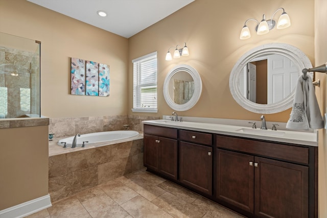 bathroom featuring tiled tub, tile patterned flooring, and vanity