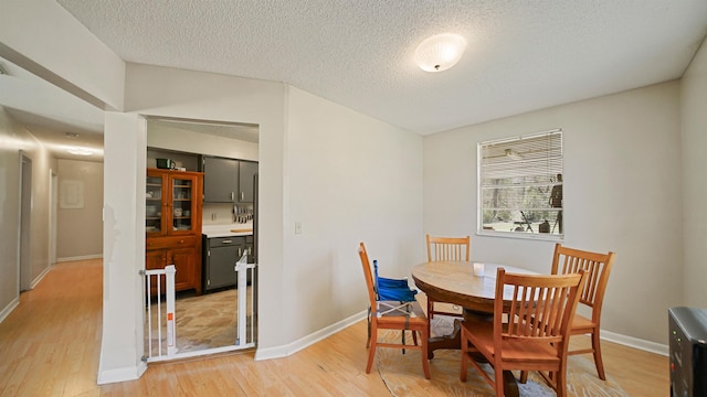 11519 W Confederate Dr, Glen Saint Mary, FL 32040 - dining space with a textured ceiling, light wood-type flooring, and baseboards