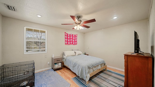11519 W Confederate Dr, Glen Saint Mary, FL 32040 - bedroom featuring baseboards, visible vents, ceiling fan, a textured ceiling, and light wood-type flooring