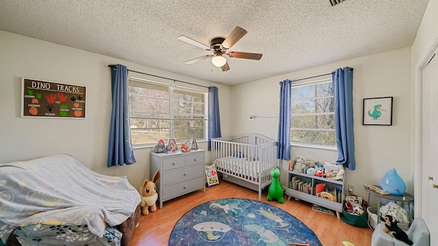 11519 W Confederate Dr, Glen Saint Mary, FL 32040 - bedroom featuring a textured ceiling, wood finished floors, and ceiling fan