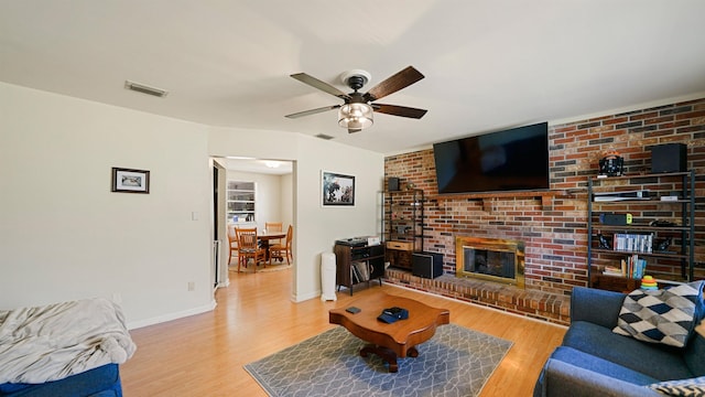 11519 W Confederate Dr, Glen Saint Mary, FL 32040 - living area with a ceiling fan, baseboards, wood finished floors, visible vents, and a fireplace