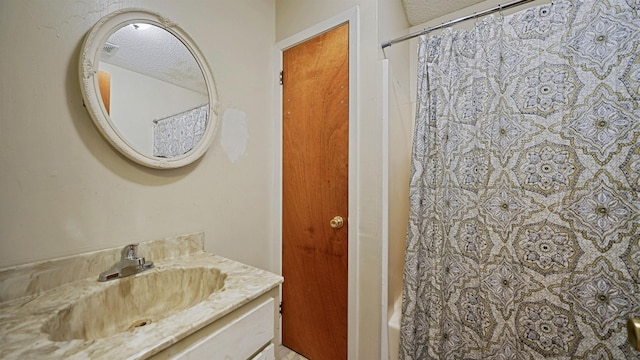 11519 W Confederate Dr, Glen Saint Mary, FL 32040 - bathroom featuring a textured ceiling, shower / tub combo with curtain, and vanity