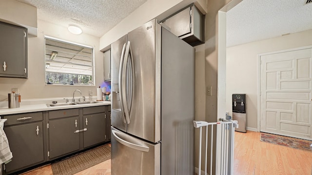 11519 W Confederate Dr, Glen Saint Mary, FL 32040 - kitchen with a textured ceiling, gray cabinets, stainless steel refrigerator with ice dispenser, and a sink