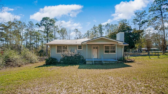 11519 W Confederate Dr, Glen Saint Mary, FL 32040 - view of front of home featuring stucco siding, a front lawn, fence, covered porch, and metal roof