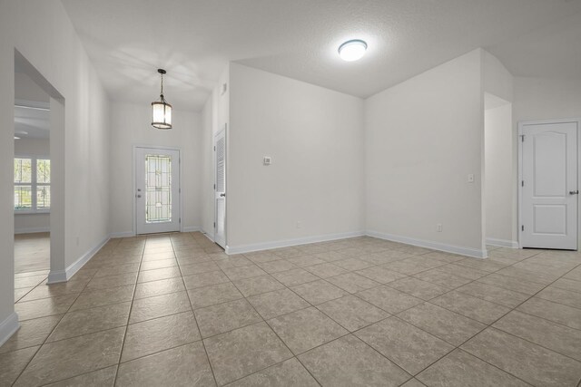 entrance foyer featuring light tile patterned floors and baseboards