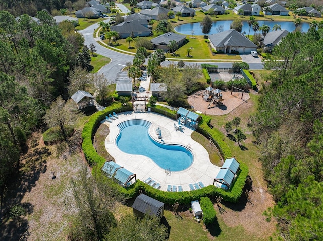 birds eye view of property with a residential view and a water view