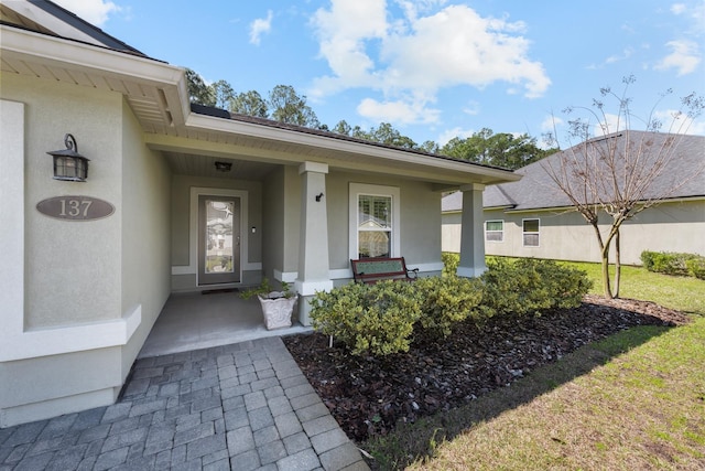 entrance to property with stucco siding