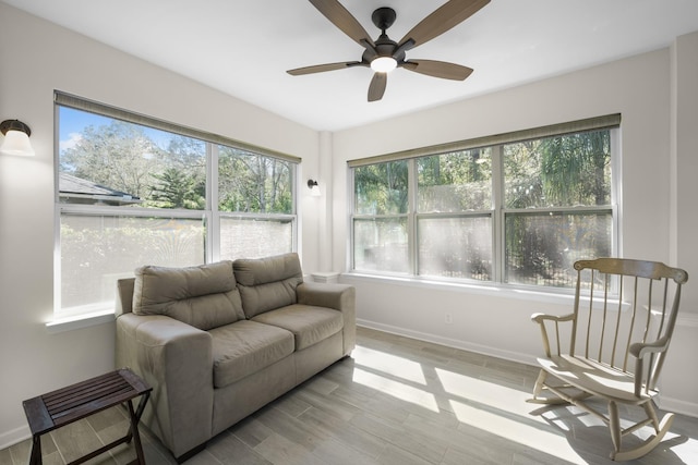 sunroom / solarium featuring ceiling fan