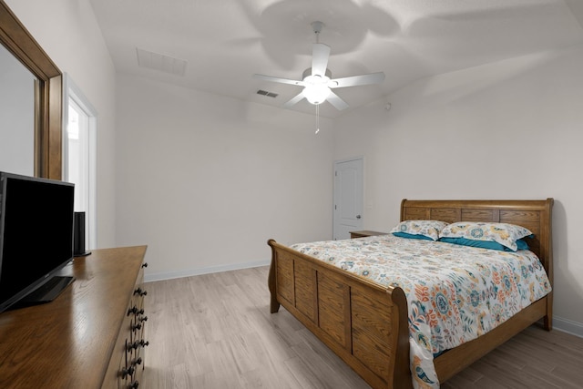 bedroom featuring a ceiling fan, baseboards, visible vents, and light wood-type flooring