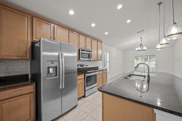 kitchen with visible vents, backsplash, light tile patterned floors, stainless steel appliances, and a sink