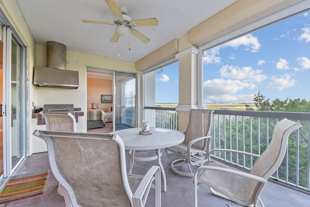 sunroom / solarium featuring ceiling fan