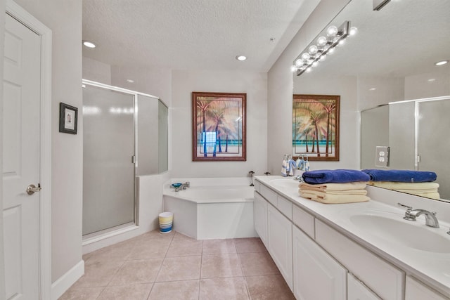 bathroom featuring tile patterned flooring, shower with separate bathtub, a textured ceiling, and vanity