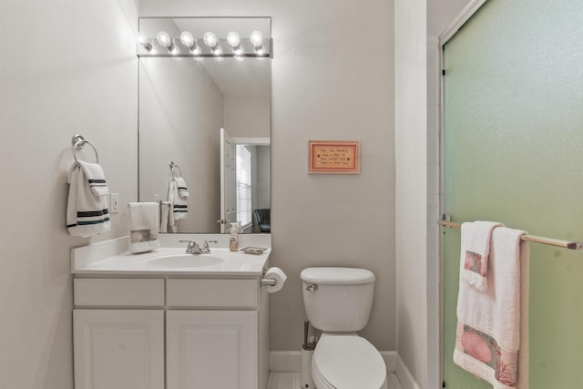 bathroom featuring walk in shower, vanity, and toilet