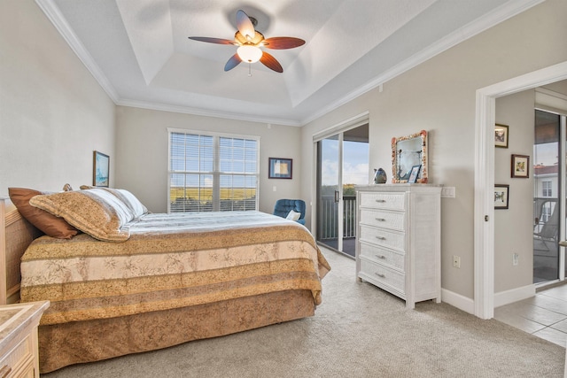 bedroom featuring access to exterior, light carpet, a tray ceiling, and ceiling fan