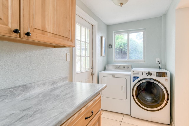 159 Southwind Dr, Saint Augustine, FL 32080 - washroom featuring washing machine and dryer, cabinet space, and light tile patterned floors