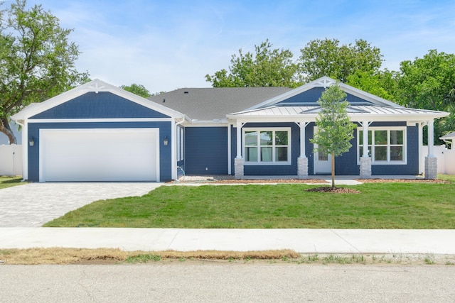 ranch-style home with a garage and a front yard