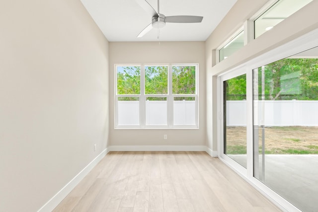 unfurnished sunroom featuring ceiling fan