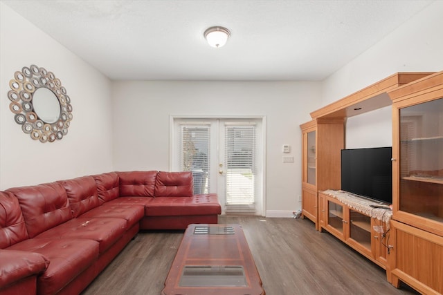 living room with french doors and dark wood-type flooring