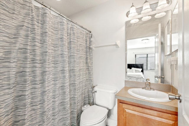 bathroom with vanity, a shower with shower curtain, and toilet