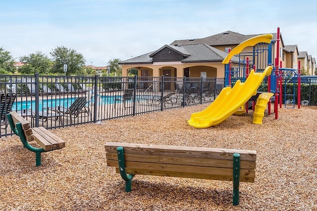 view of playground featuring a community pool