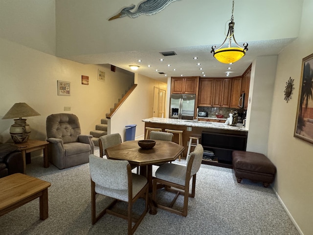 dining room featuring light colored carpet