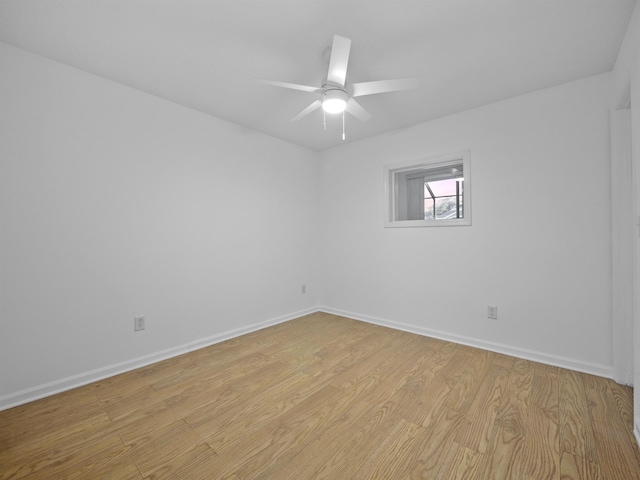 empty room with light wood-type flooring, baseboards, and a ceiling fan