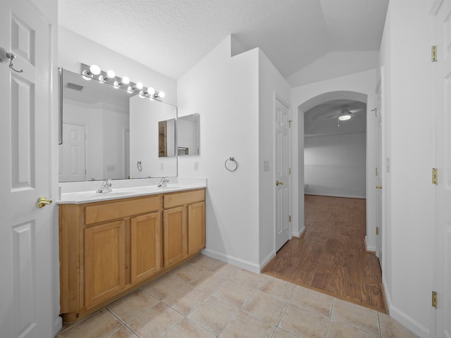 bathroom featuring tile patterned flooring, visible vents, a sink, and a textured ceiling