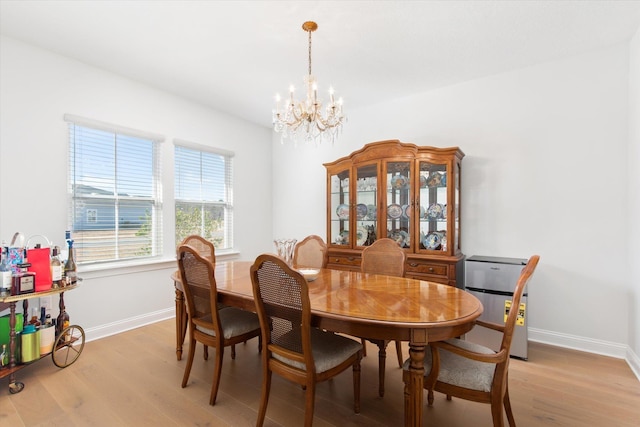 dining room featuring a chandelier and light wood-type flooring