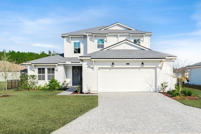 view of front of house featuring a garage and a front lawn