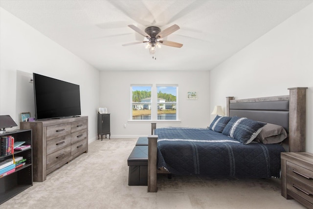 bedroom with ceiling fan and light carpet