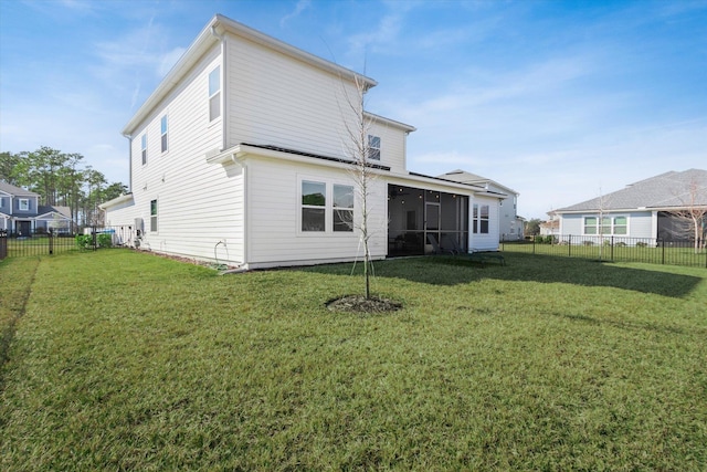 back of house with a yard and a sunroom