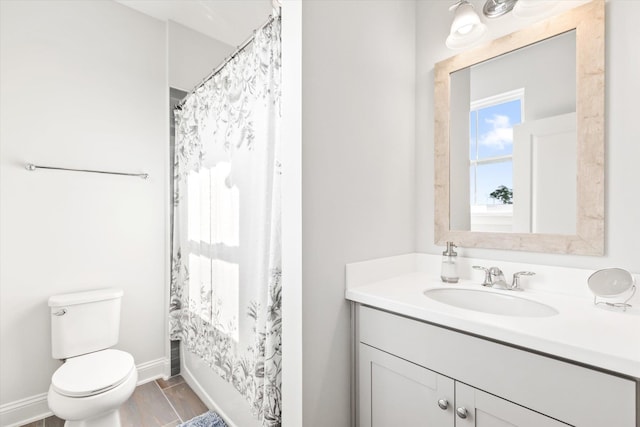 bathroom featuring vanity, a shower with shower curtain, and toilet