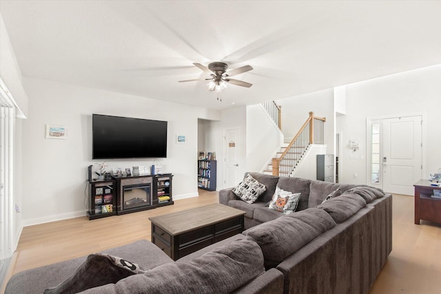 living room featuring light hardwood / wood-style floors and ceiling fan