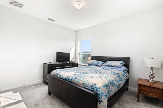 bedroom featuring light colored carpet