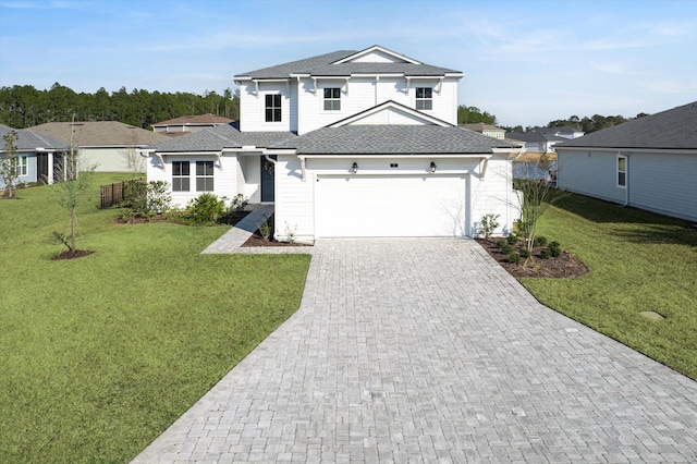 view of front of home with a garage and a front lawn