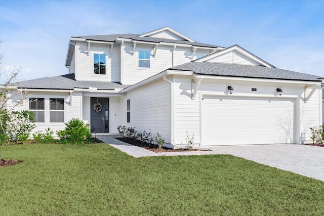 view of front of house featuring a garage and a front yard