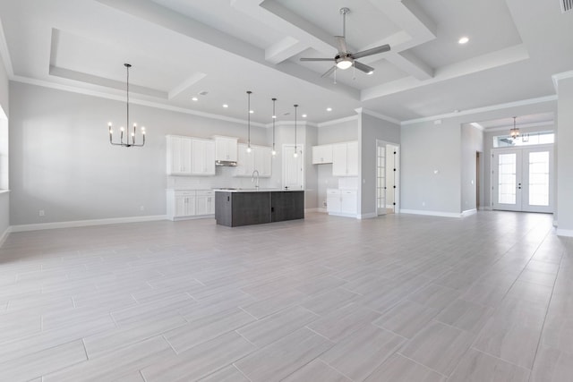 unfurnished living room with baseboards, recessed lighting, french doors, a raised ceiling, and ceiling fan with notable chandelier