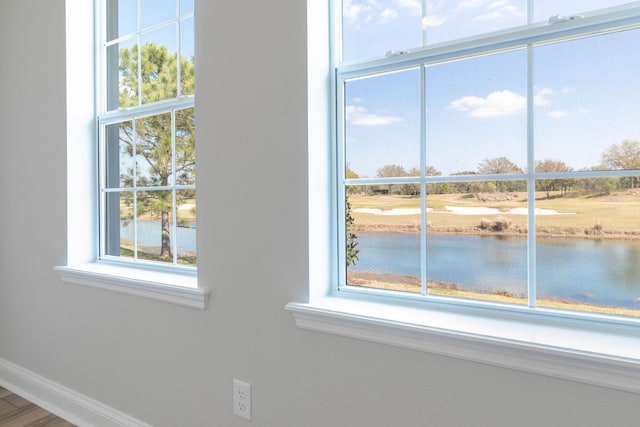 interior details with baseboards and a water view