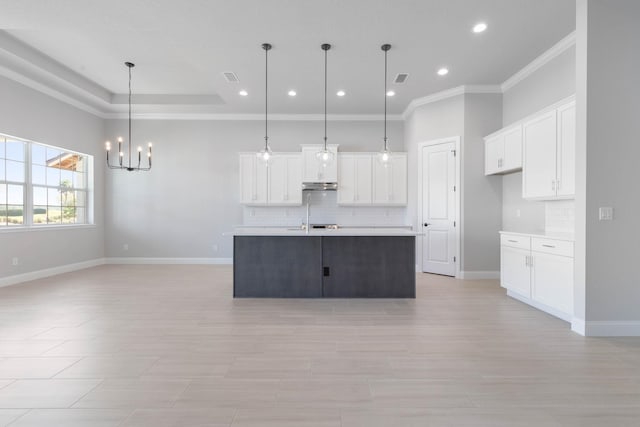 kitchen with backsplash, white cabinets, recessed lighting, and a notable chandelier