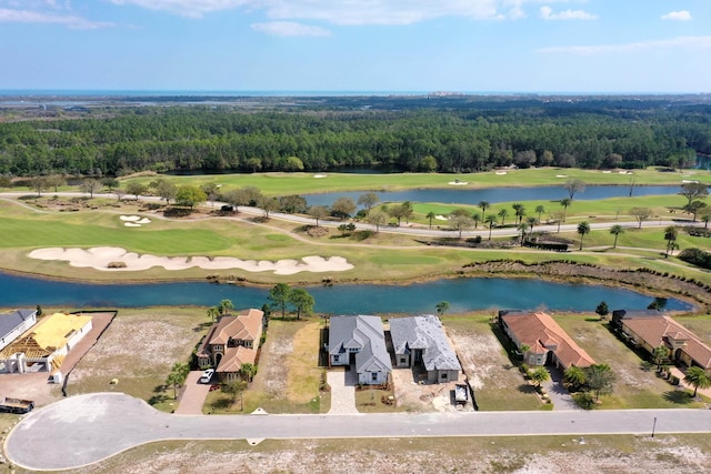 birds eye view of property with view of golf course, a residential view, a water view, and a forest view