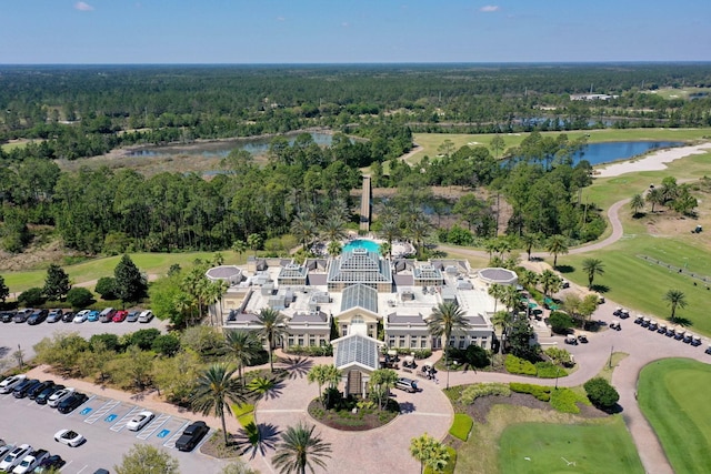 bird's eye view featuring a water view, a forest view, and view of golf course