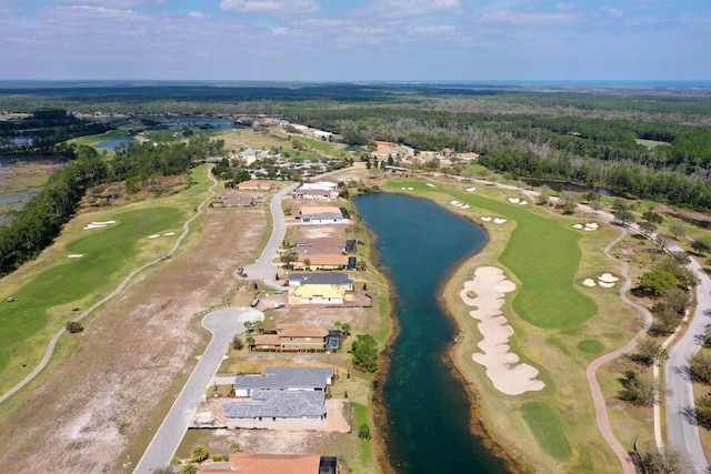 drone / aerial view featuring a water view, a wooded view, view of golf course, and a residential view