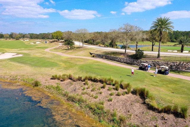 view of property's community with a water view and view of golf course