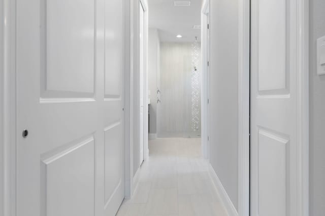 hallway featuring light tile patterned floors