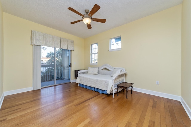 bedroom with ceiling fan, access to outside, and light hardwood / wood-style flooring