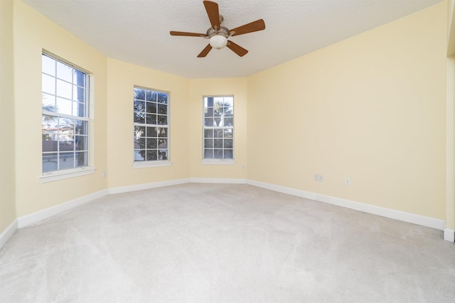 carpeted empty room with a textured ceiling and ceiling fan