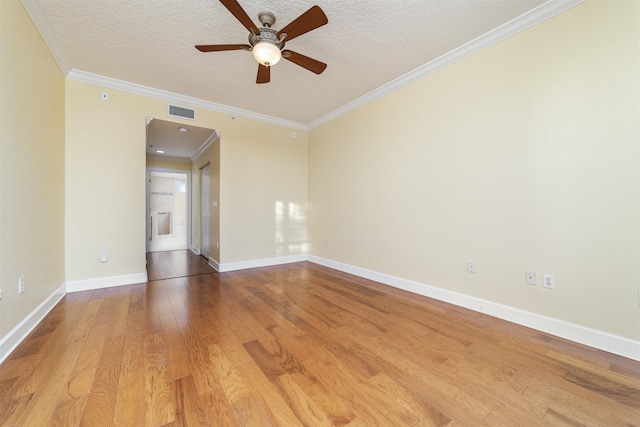 spare room with ceiling fan, crown molding, wood-type flooring, and a textured ceiling