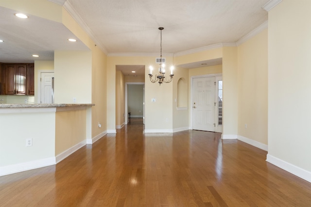 interior space featuring crown molding, hardwood / wood-style floors, and an inviting chandelier