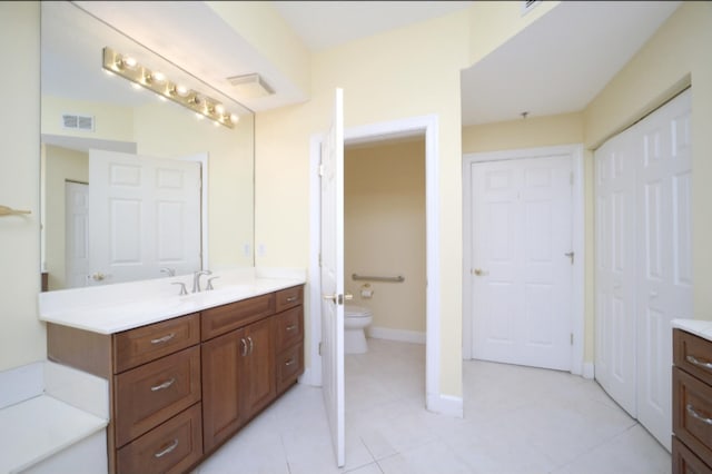 bathroom featuring tile patterned floors, vanity, and toilet